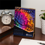 GIA desk calendar February page, featuring bright rainbow photomicrograph