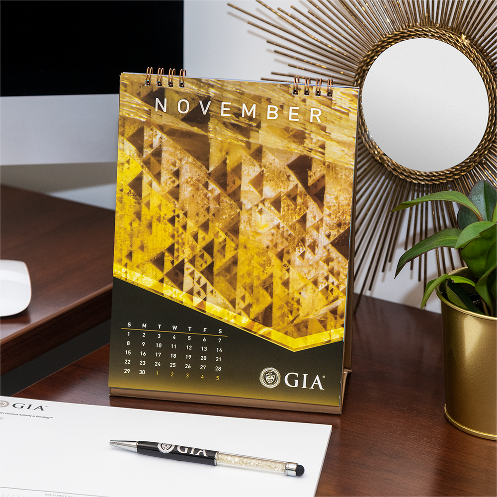GIA desk calendar November page, featuring yellow geometric photomicrograph